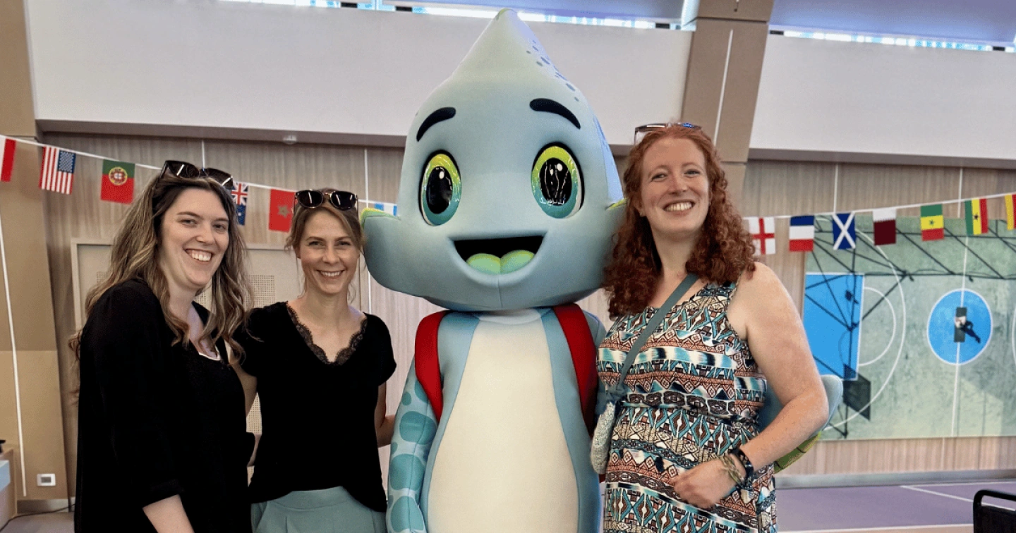 Das neue Kids-Club-Maskottchen Finni mit EURESAreisen Teammitgliedern an Bord von Mein Schiff Flow.